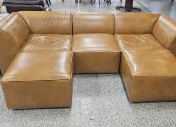 Tan three piece leather sectional inside the ReStore